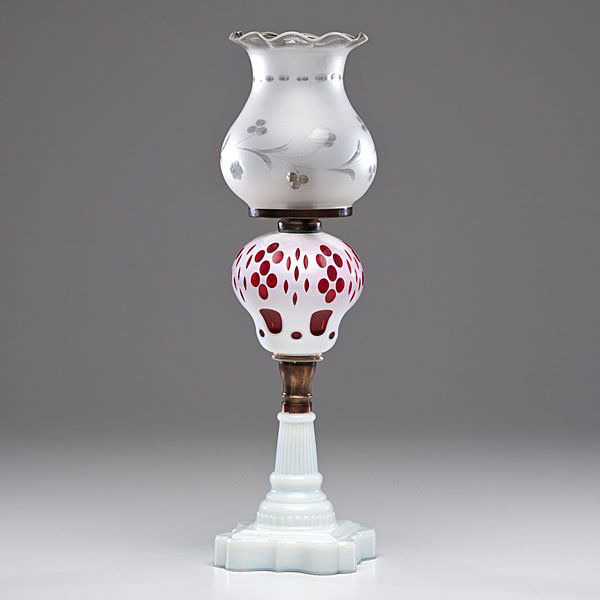 Sandwich Glass Ruby Lamp with Pressed Base : American, second half of 19th century. Cut overlay glass stand lamp, having cut alabaster white to ruby quatrefoil pattern pyriform font, mounted on milky white pressed glass base. Attributed to the