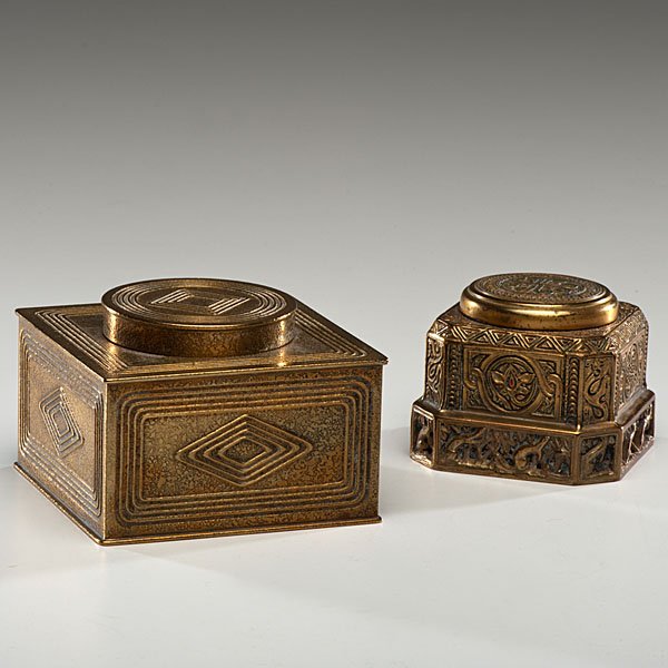 Tiffany Studios Bronze Inkwells : American, early 20th century. Two Tiffany Studios bronze inkwells, both with hinged lids and glass inserts, one in the Venetian pattern, with hinged lid and glass insert, marked Tiffany Studios / New 