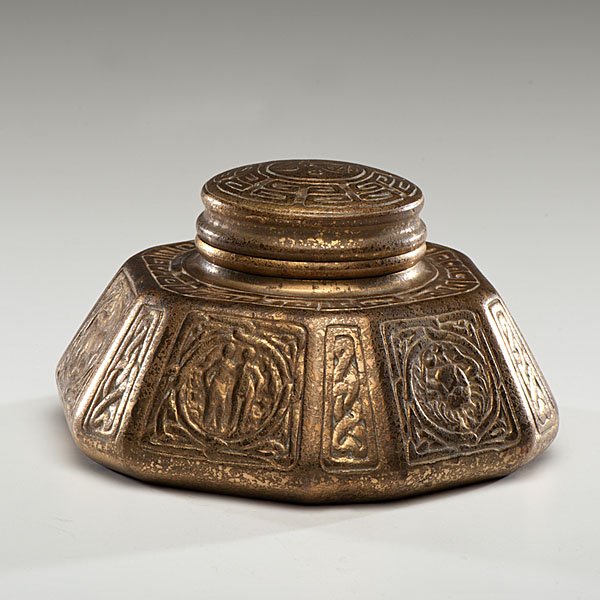 Tiffany Studios Zodiac Pattern Inkwell : American, early 20th century. A Tiffany Studios bronze inkwell in the Zodiac pattern, of hexagonal form with hinged lid, marked Tiffany Studios / New York / 1072 on underside; ht. 3.75, dia. 6.75 in.�
