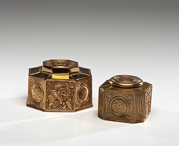 Tiffany Studios Inkwells, Bookmark Pattern : American, early 20th century. Two Tiffany Studios bronze dore inkwells in the Bookmark pattern, with a hinged lid and glass insert, larger marked Tiffany Studios / New York / 864 on underside, smaller