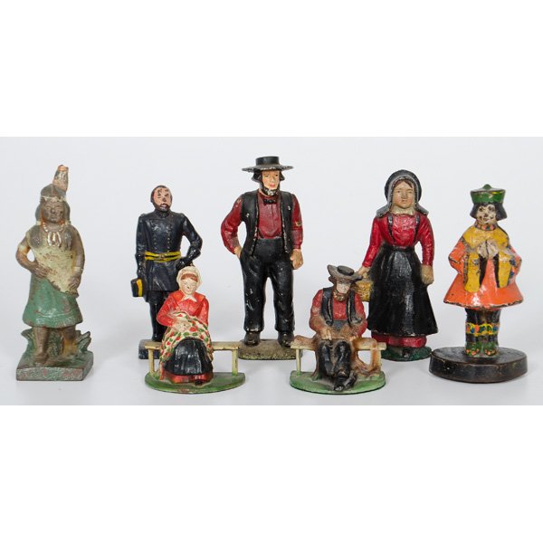 Cast Iron Figural Door Stops and Bookends : American. A group of five painted cast iron figural door stops including a standing Amish man and woman, an Asian figure, U. S. Grant, an "Indian Squaw" and a pair of bookends of a seated Amish man an
