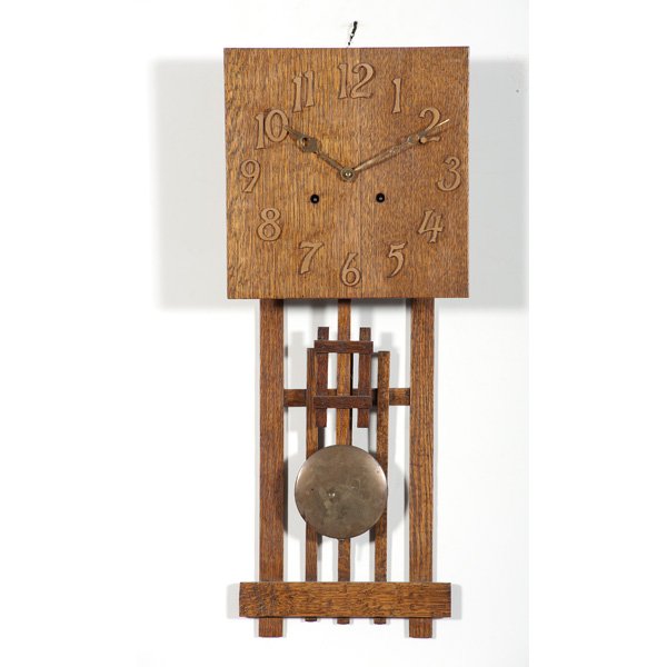 Arts and Crafts Oak Wall Clock : American, 20th century. An Arts and Crafts oak wall clock with key wind; lg. 29 in.