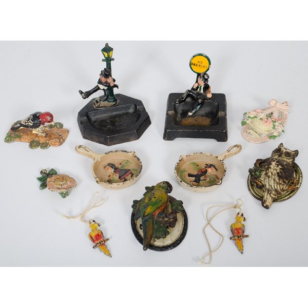 Cast Iron Door Knockers and Ash Trays : A group of cast iron and painted figural door knockers, including two parrots, an owl, two florals, and four cast iron ashtrays, including a high hat sign post, a No Parking by Wilton and an Amish gir