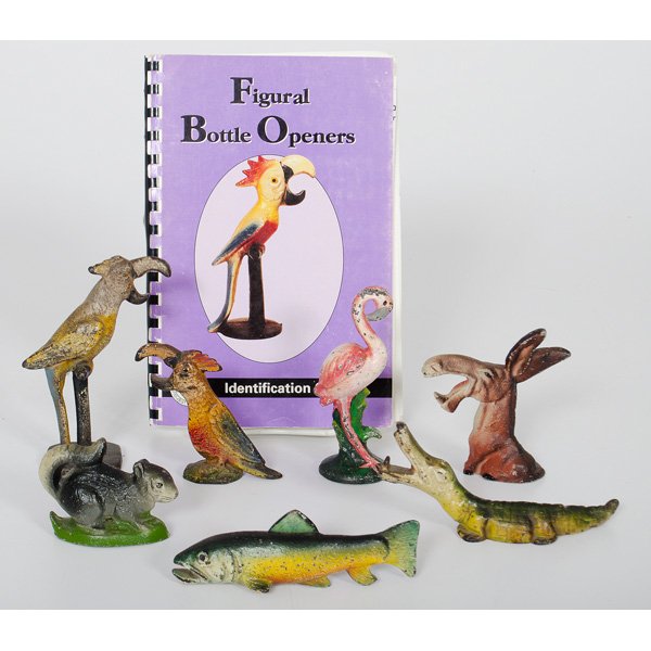 Cast Iron Figural Bottle Openers, Plus : An assembled group of seven polychrome cast iron bottle openers, including two parrots, a flamingo, a donkey, an alligator, a chipmunk and a trout; tallest ht. 5 in., PLUS the book Figural Bottle Open