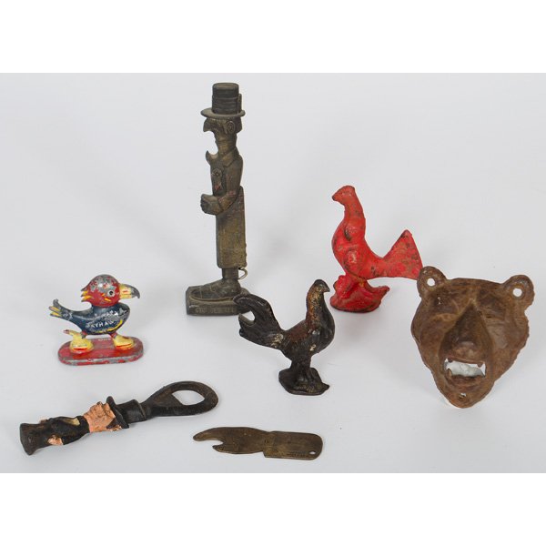 Cast Iron Figural Bottle Openers, Plus : An assembled group of six cast iron figural bottle openers, including a grisly bear, a jayhawk, two roosters, man with top hat, "Old Snifter" with hidden corkscrew, PLUS a brass bottle opener advertis