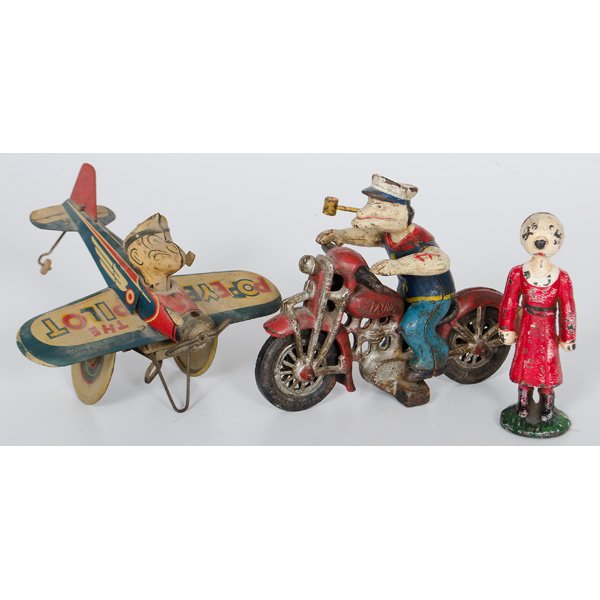 Hubley Cast Iron Popeye Motorcycle and Olive Oil : A Hubley cast iron Popeye motorcycle patrol with movable arms and a cast iron Olive Oil standing bank, PLUS a King Features Syndicate tin wind up Popeye the Pilot toy; motorcycle lg. 9 in.