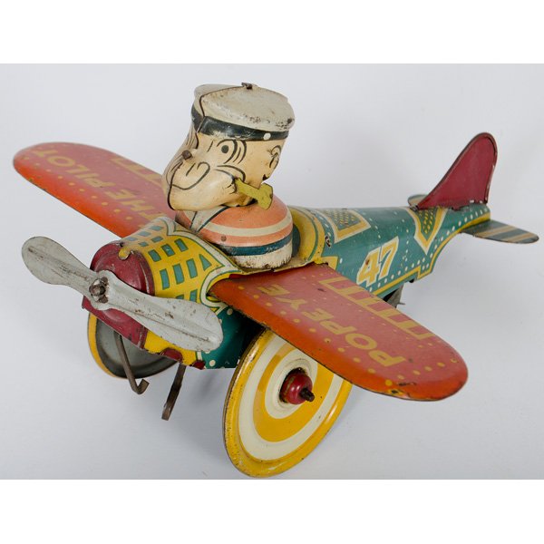 Popeye the Pilot Wind-Up Toy : A Louis Marx & Co. Popeye the Pilot wind-up toy, lithographed tin with seated Popeye, key wind operated; lg. 9 in.