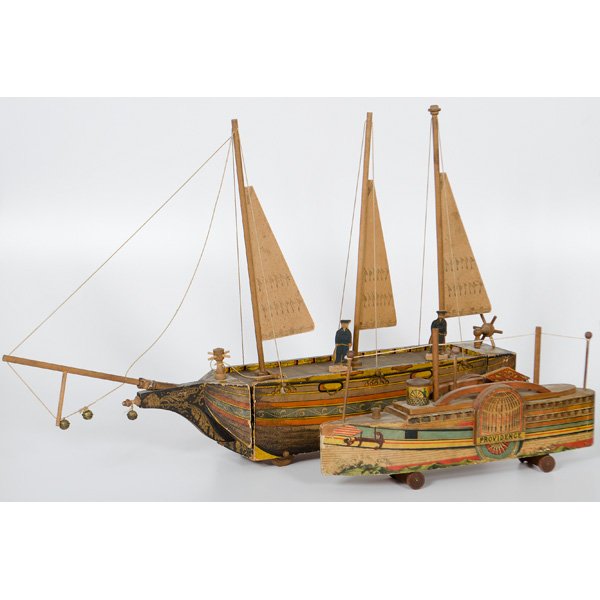 Lithographed Paper and Wood Toy Ships : Two lithographed paper and wood toy ships, one a Providence steamship by Bliss with removable top on four wheels, the other an Ocean Wave sailing ship, includes original sails, two sailors and rudder,
