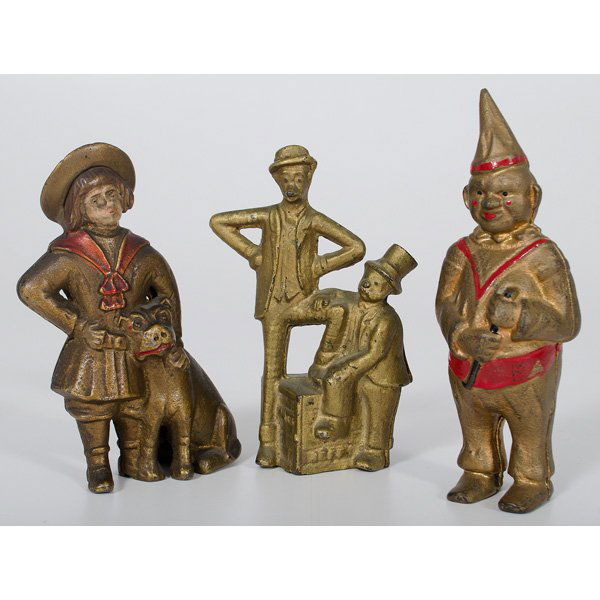 Cast Iron Still Character Banks : American. An assembled group of three cast iron still banks, including a Buster Brown and Tige bank, a Mutt and Jeff bank, Moore #157 and a Clown bank, Moore #211; tallest ht. 6 in. Provenance: Est