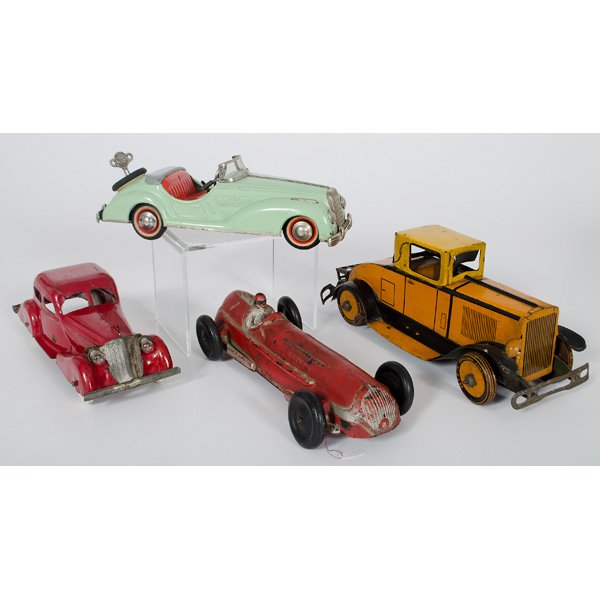 Marx, Wyandotte and Distler Cars, Plus : 20th century. Three metal toy cars, including orange and yellow Marx wind up car with driver, red Wyandotte car with glass headlights and new tires, a pale green Distler wind up car with gearbox and o