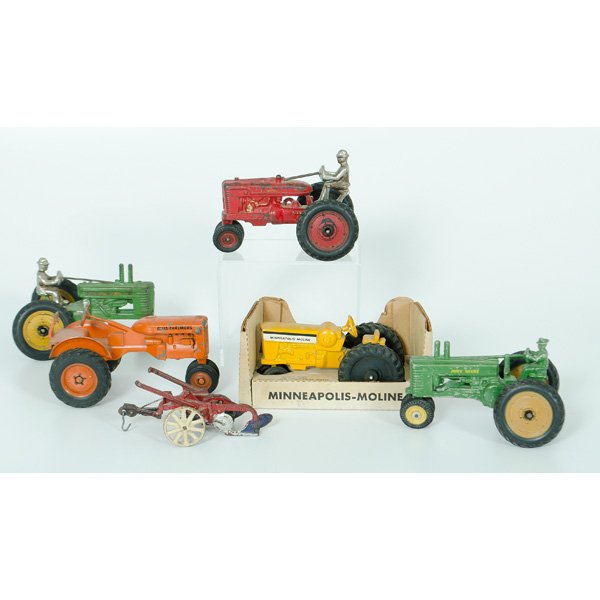 Cast Iron Toy Tractors, Plus : An assembled group of five cast iron toy tractors, including an Arcade John Deere tractor, an Arcade Farmall tractor, an Allis Chalmers tractor, a John Deere tractor and a Minneapolis-Moline tractor b