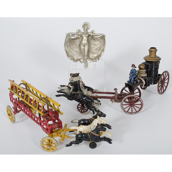 Kenton Cast Iron Pumper and Ladder Wagon, Plus : American, 19th century. Two Kenton cast iron fire equipment toys, including ladder wagon and pumper, both drawn by three horses. Pumper retains two metal ladders and two drivers. Pumper retains bell,