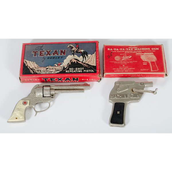 Hubley and Kilgore Boxed Toy Guns : American, 20th century. Two cap guns in original boxes, one 1938 "Ra-ta-ta-tat Paper Cap Machine Gun" by Kilgore, as well as a "The Texan" 50-shot repeating rifle by Hubley; "Texan" gun lg. 10 in.