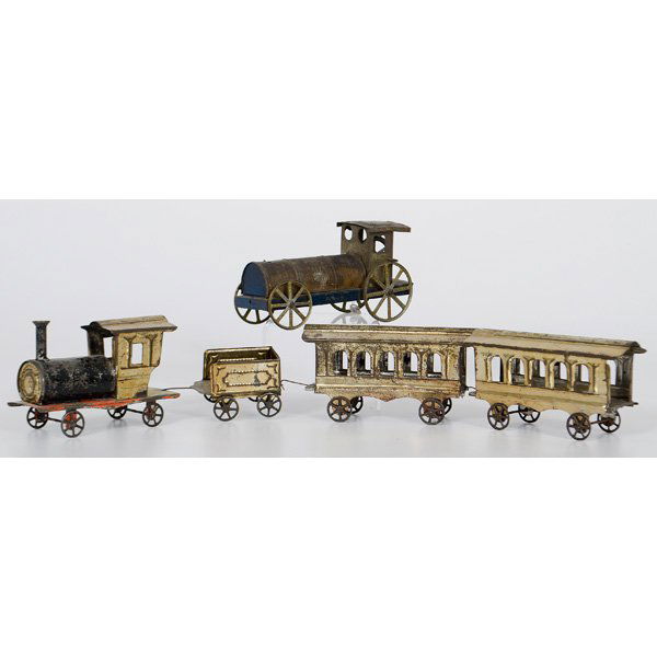 Painted Tin Toy Trains : American, 19th century. Tin train toys, including gilt tin and red painted set of locomotive, tender, and two passenger cars. Also included is a larger locomotive with traces of gilding and blue paint