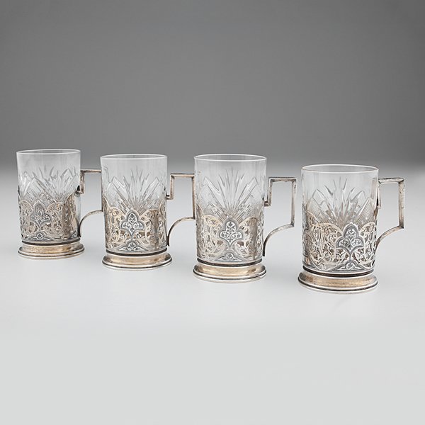 Russian Silver Tea Glass Holders with Cut Glass : Russia, mid-20th century. Group of four Soviet era silver tea glass holders with fitted cut glasses. Holders all ornamented with niello designs and hand engraving; ht. 4.25 in., silver wt. 9.59ozt (29