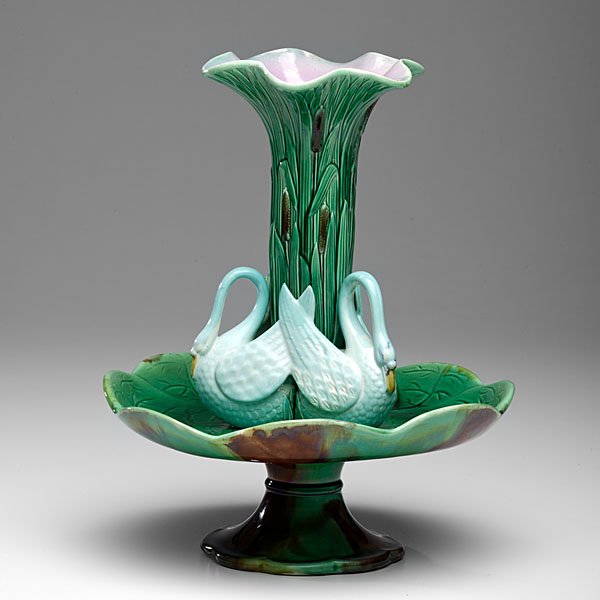 Minton Majolica Swan Épergne : English, 19th century. Minton attributed majolica épergne in the form of water lily pads surmounted by a swan encircled cat o' nine tails vase, unmarked; ht. 14.25 in.