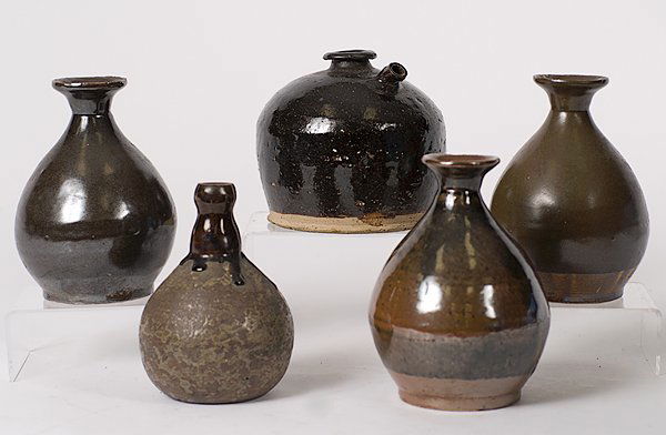Japanese Wine Vessels : Japanese, an assembled group of five earthenware wine vessels including one jug with a spout, three baluster form vessels with everted rims, and one vessel with a globular body with slender neck, all