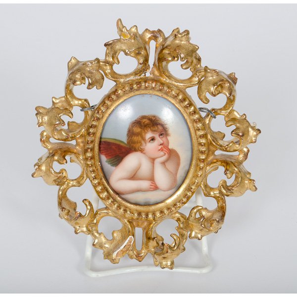 Austrian Painted Plaque in Carved Frame : Probably Austrian, early 20th century. A hand painted porcelain plaque with cherub, carved frame; overall 7 x 6 in.