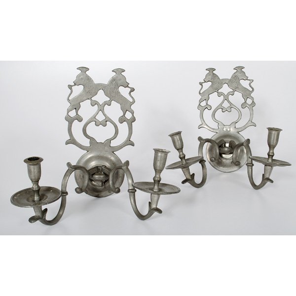 Armed Pewter Wall Sconces : Continental (possibly British). A pair of sconces, each having two scrolling arms, and mounts of two lions wearing crowns, varying marks on arms, each mount having an indecipherable mark with a crow
