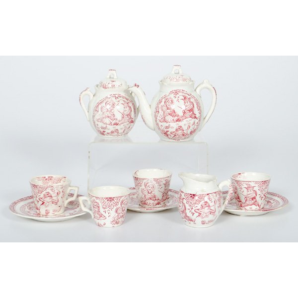 Punch and Judy Staffordshire Child's Tea Set : English, late 19th century. A partial child's tea set in the cranberry red transferprinted Punch pattern, produced by C. Allerton & Sons, including teapot, master sugar, creamer, four teacups and th