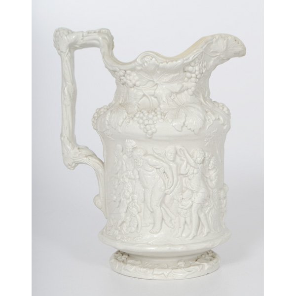 Charles Meigh 'Bacchanalian' Jug : English, 19th century. A molded salt-glazed stoneware water pitcher with high relief depiction of Bacchanalian figural scene, having applied white Charles Meigh coat-of-arms cartouche registry on bott