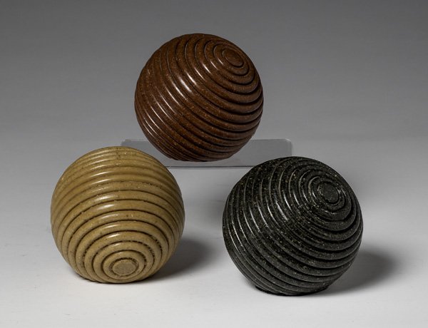 Turned Hardstone Ball Paperweights : Contemporary. Three turned hardstone balls, decorative or used as paperweights, each with a cut on the side to keep them stable; ht. of each 4.25 in.