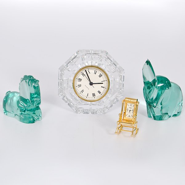 Crystal Clock and Animals : A group of desk accouterments; two green glass paper weights - a unicorn and an elephant, a desk clock in a cut glass case and a small desk clock in a miniature rocking chair; largest ht. 5 in.