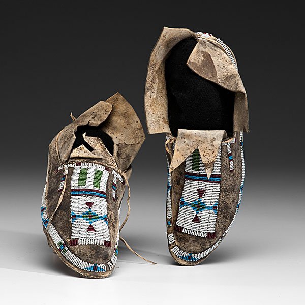 Cheyenne Beaded Hide Moccasins : sinew-sewn and beaded using colors of rose, light blue, white, and translucent green; forked tongue and split heel seam, length 10.75 in. ca 1900