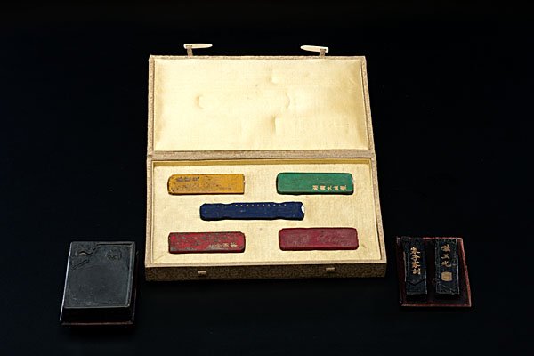 Chinese Inkstones : Chinese, 19th/20th century. A collection of seven (7) inkstones, including a fitted box housing five colorful stones, each well carved in the form of musical instruments, another boxed black stone