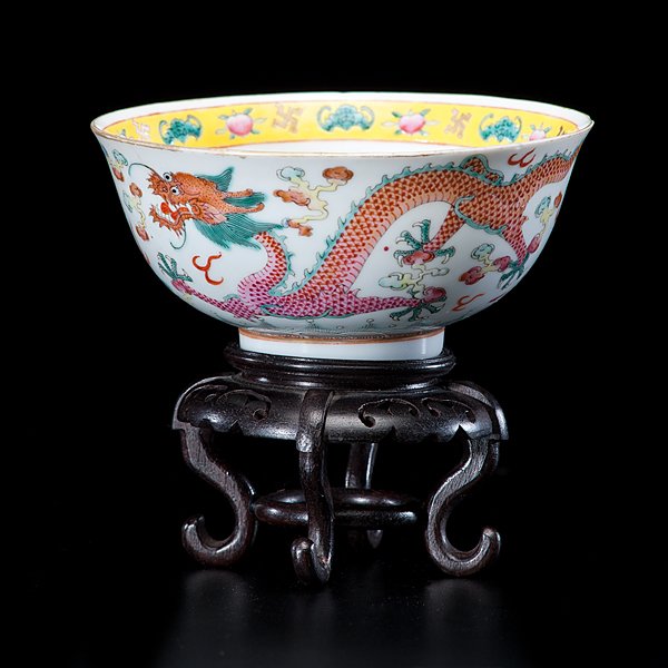 Chinese Guangxu Period Porcelain Dragon Bowl : Chinese, Guangxu period. A porcelain bowl decorated with a pair of famille rose dragons and celestial pearls, the interior with an iron red dragon and a border of bats and peaches around the rim, havi