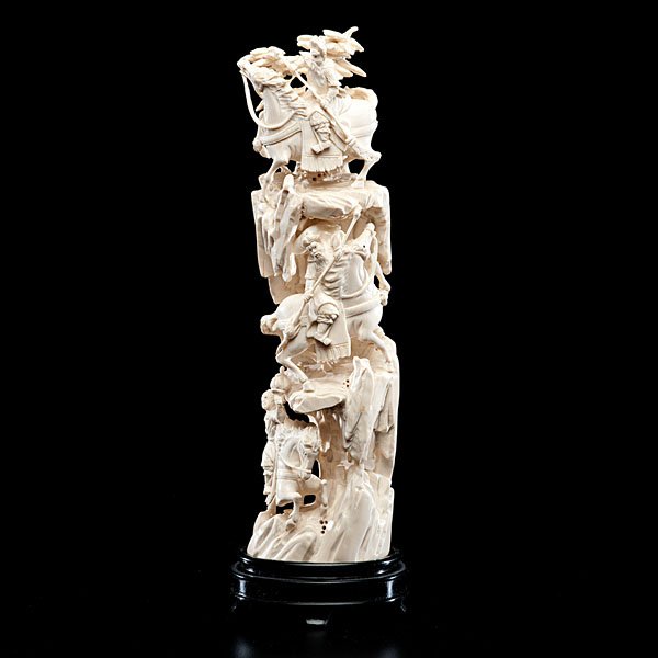 Chinese Ivory Mountain Carving with Warriors : Chinese. A mountain carving in ivory, carved cleverly to reveal warrior ascending a mountain, each on horseback; ht. 13..5 in. (w/stand)