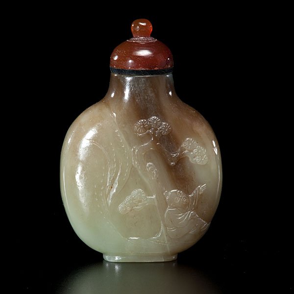 Chinese Celadon Jade Carved Snuff Bottle : Chinese, 19th century. A well carved and polished gray celadon jade bottle having a relief carving revealing a flutist under a tree, streaks of russet and agate top; ht. 2.75 in.