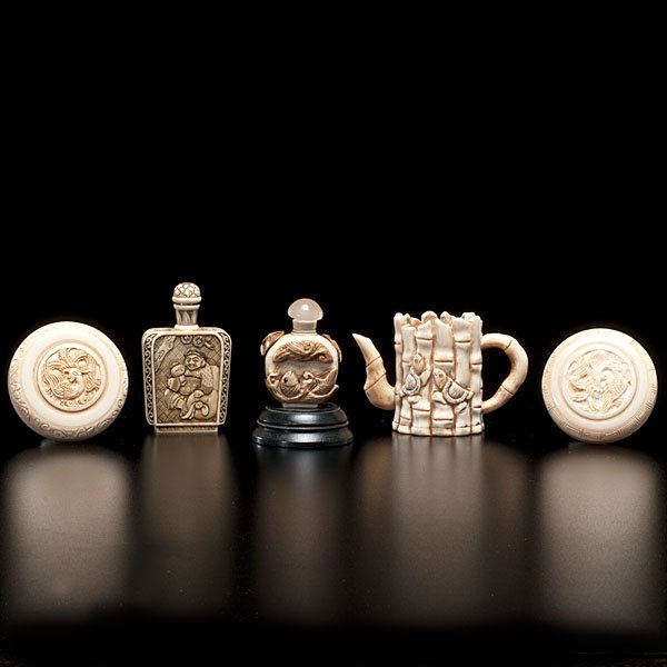 Collection of Chinese Ivory Snuff Bottles, Carved: Chinese, early 20th century. Two carved and inked lidded ivory snuff bottles, both marked; ht. of tallest 2.6 in. PLUS two carved ivory boxes, one with a wooden base, and one carved bone teapot.