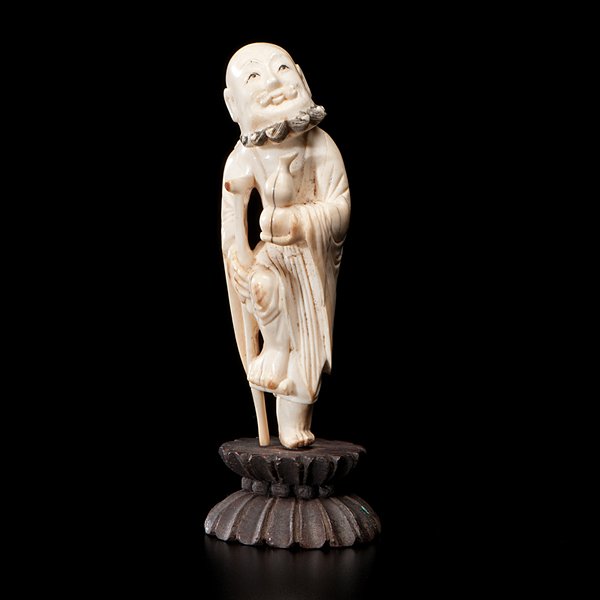 19th century Chinese Ivory Carving of Figure with: Chinese, probably early 19th century. A small ivory figure with cane and gourd, on lotus stand; ht. 5 in.