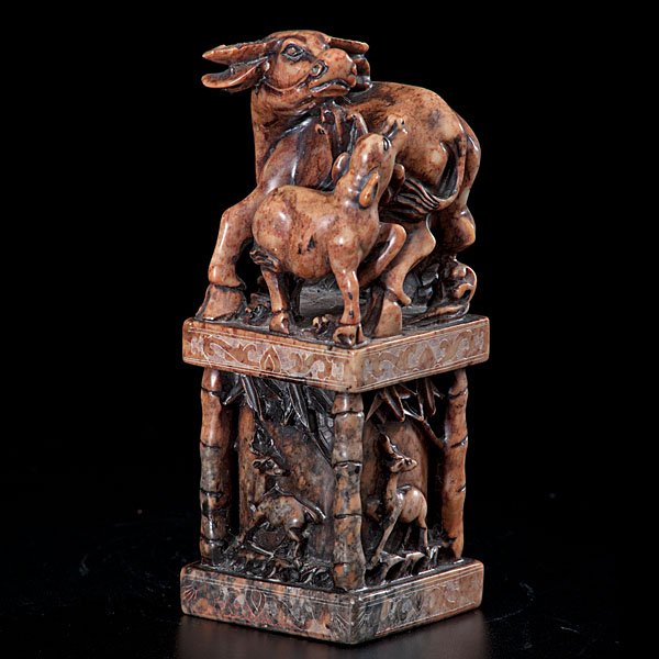 A Fine Chinese Carved-Soapstone Seal with Water Buffalo: Chinese, late 19th/early 20th century. A finely carved-soapstone seal surmounted by two water buffalos, the largest with its head turned sharply to the left over its back, the vertical columns direc