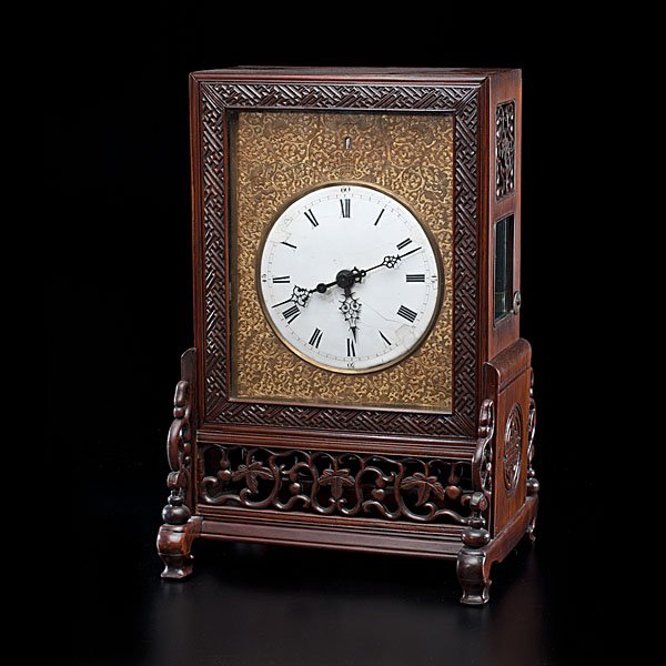 19th Century Chinese "Screen" Clock : Chinese, early 19th century. With rosewood case, highly carved base. Double fusee movement striking the hours and quarters. Crown wheel escapement and center seconds. Brass dial surround inclu