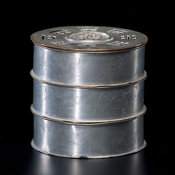 Round Pewter Chinese Incense Clock : Chinese, ca 1900. A round petwer incense clock, marked for Thu Ning, Sang Tou, Yan Ho Shan. Cover decorated with 8 trigrams, and containing 5 pieces (missing spoon). Ht. 3.5 in.