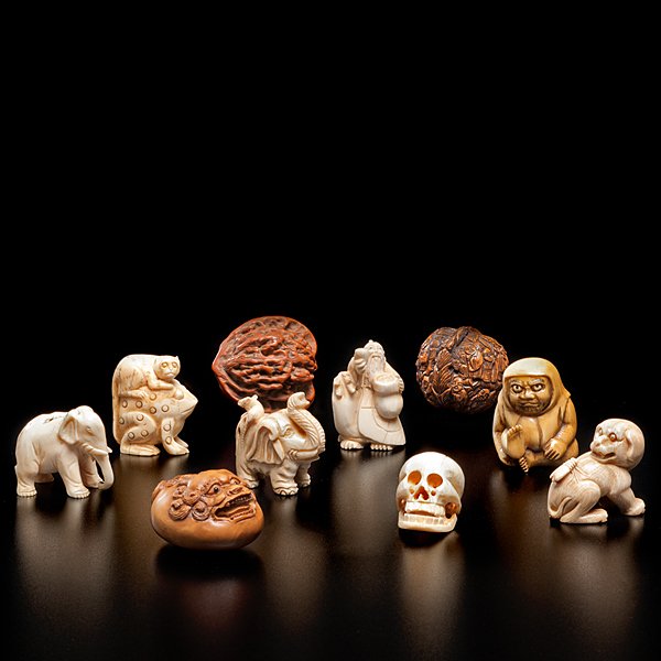 Collection of Japanese Netsuke and Carvings : Japanese, 19th/20th century. A collection of ten carvings, including 7 netsuke in ivory, some 19th century. Also including a pair of seed carvings and an unusual wood carved netsuke with carved be