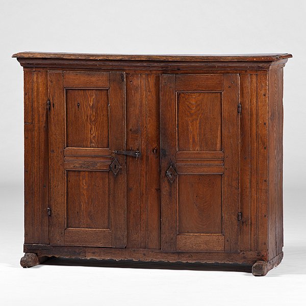 English Oak Cupboard on Shoe Feet : English Oak Cupboard on Shoe Feet English, 19th century. A cupboard in oak, having a molded cornice over two paneled doors, on shoe feet; ht. 45, wd. 56.75, dp. 20 in.