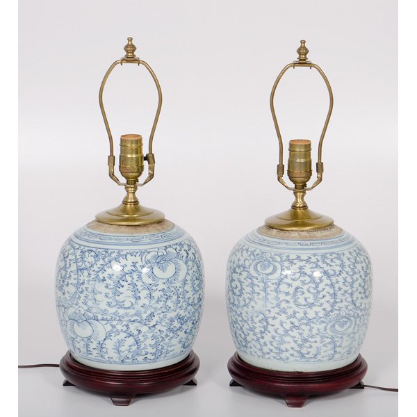 Chinese Blue and White Porcelain Lamps : Chinese Blue and White Porcelain Lamps Chinese, 19th century. A pair of blue and white porcelain lamps of ginger jar form, on rosewood stands; ht. 10 in. (without harps).