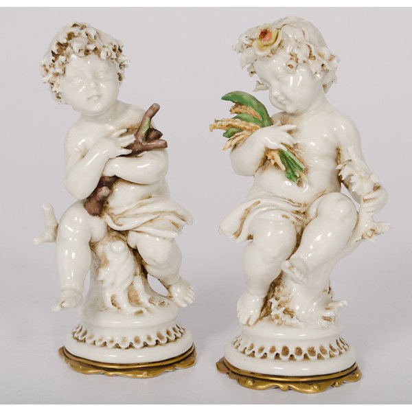Pair of Capo-Di-Monte Porcelain Figures : Pair of Capo-Di-Monte Porcelain Figures Italian, late 19th-early 20th century. A pair of porcelain Capo-Di-Monte cherubesque figures, the male hugging a bundle of branches while the female holds sta