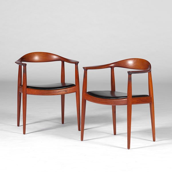Hans Wegner Armchairs : Hans Wegner Armchairs Danish, 20th century. A pair of Hans Wegner teak armchairs, with black leather upholstered seats; oah 30 in.