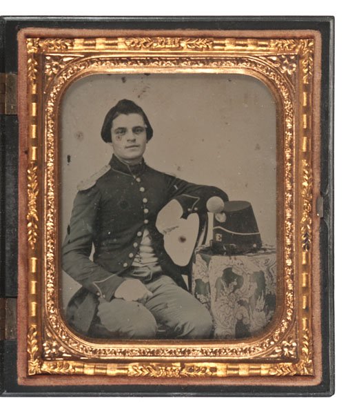 Sixth Plate Ambrotype of a Soldier Posed with his: Sixth Plate Ambrotype of a Soldier Posed with his Shako Sixth plate ambrotype of an unidentified soldier wearing a 9-button frock coat with brass shoulder scales, which was favored by New England re