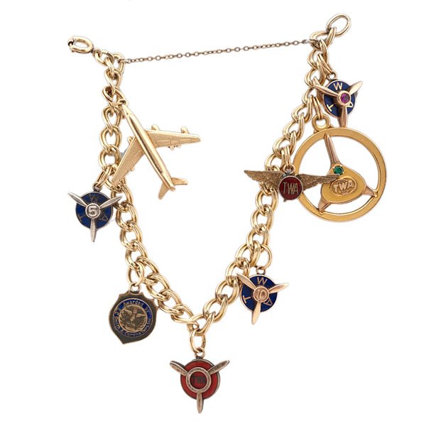 Vintage TWA Flight Pin Charm Bracelet : Vintage TWA Flight Pin Charm Bracelet Vintage TWA awards pins converted to a charm bracelet. Contains four propeller charms, one set of flight wings, one large charm with a green stone, one Smith & 