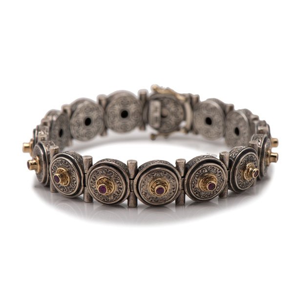 Konstantino Sterling and 18 Karat Ruby Bracelet : Konstantino Sterling and 18 Karat Ruby Bracelet Ladies Konstantino sterling silver and 18k yellow gold bracelet containing 15, 2.2mm round rubies set in bezels. 31.10 dwt. 7 in. long Konstantino jew