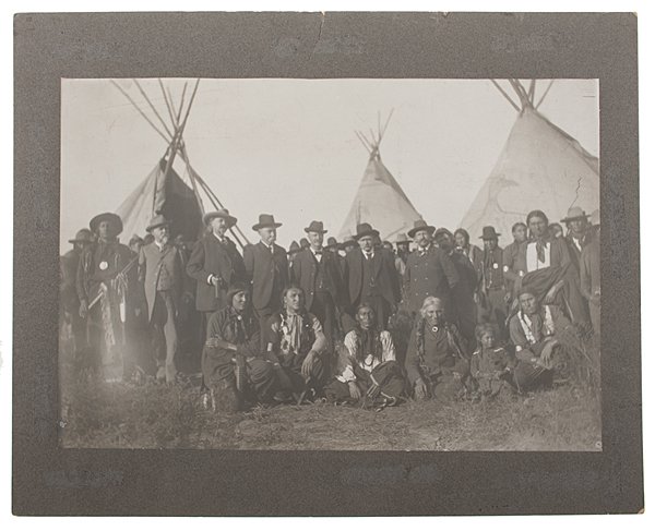 William F. Cody and Sioux Indians (At Pine Ridge?) : William F. Cody and Sioux Indians (At Pine Ridge?) 11.75 x 16.75 silver gelatin print, mounted to 16 x 20, matted and framed under glass to 18 x 22 in. Provenance: Descended directly in the famil