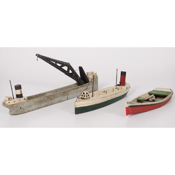 American Wooden Toy Boats : American Wooden Toy Boats American, early 20th century. A group of three wooden boat toys, including a rowboat, an ocean liner and as freighter complete with a metal crane; longest 23 in. Provenan