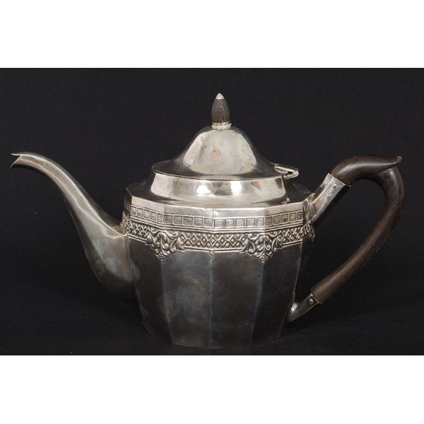 Continental Silver Teapot : Continental Silver Teapot Continental. A silver teapot with repoussé geometric and floral border, with ebony handle, unmarked; ht. 7.5 in.