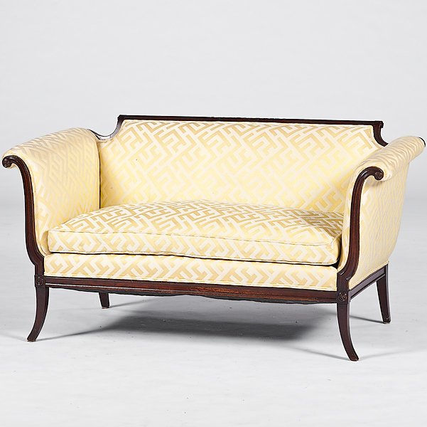 Duncan Phyfe-Style Sofa : Duncan Phyfe-Style Sofa American, 19th century. A sofa in the style of Duncan Phyfe upholstered with gold and cream geometric patterned fabric with one loose cushion, having carved crestrail, scroll