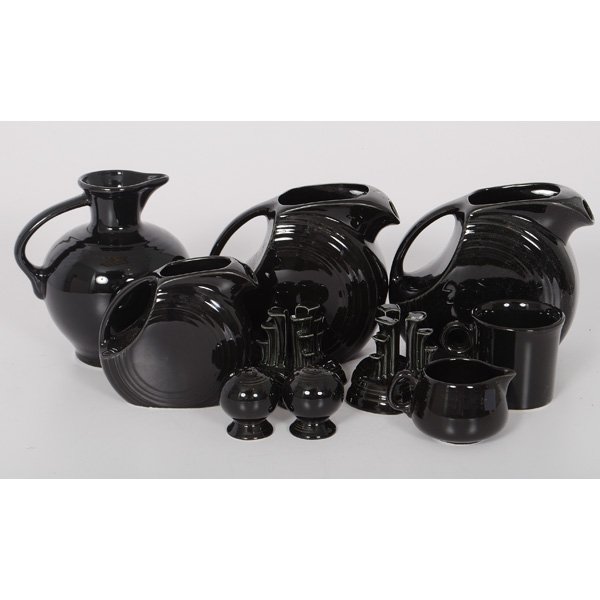 Lot of Black Fiesta Dinnerware : Lot of Black Fiesta Dinnerware Lot includes a pair of pyramid candle holders, two 7.25 in. pitchers, one 5.5 in. pitcher, an 8 in. coffee carafe, a 2.5 in. creamer, a 3.5 in. mug and a pair of salts